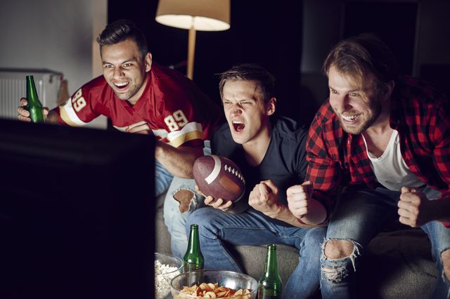 A photo of three men enjoying a TV set